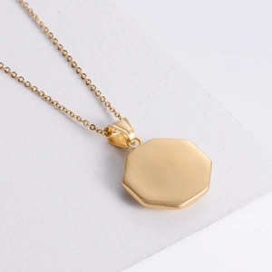 Minimalist gold plated stainless steel octagonal Tai Chi pendant necklace on white base