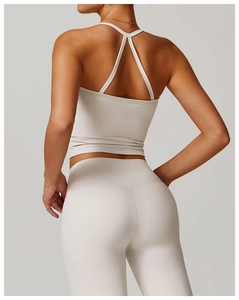 Detail shot of the crisscross back straps on a beige brushed yoga sports vest