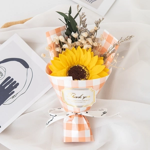 Artificial bouquet with sunflower, baby's breath, and eucalyptus in plaid wrapping