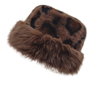 Close-up of thick leopard print faux fur bucket hat with warm plush winter texture