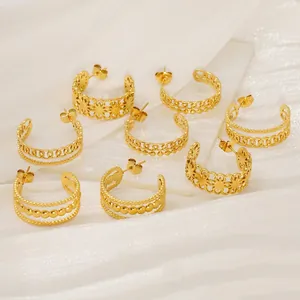 French vintage 18K gold hollow geometric hoop earrings set on silk background