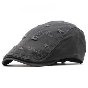 Detailed shot of dark grey washed cotton beret featuring distressed fabric and embroidery