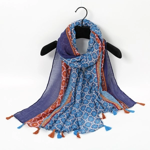 Close-up of ink butterfly print scarf with elegant fringe details on a black hanger