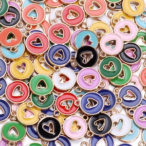 Flat lay of assorted colorful alloy heart charms for DIY jewelry making and crafting