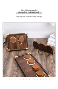 Detail of walnut wood jewelry display set with gold metal edges and brown velvet pads