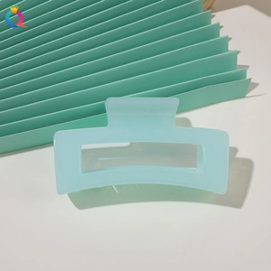 Detailed view of a light blue matte square hair claw clip on a minimal background