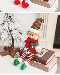 Festive Christmas elf doll detail with red and green outfit on cozy scene background