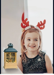 Detail of Christmas lantern with miniature winter scene and swirling snow effect light