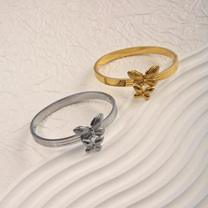 Elegant 18K gold and silver double butterfly stainless steel bangles on display