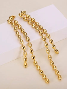 Close-up of gold beaded tassel drop earrings made of premium polished titanium steel