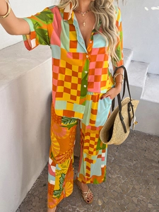Detail of bohemian two-piece set featuring vibrant geometric patterns and tropical leaves