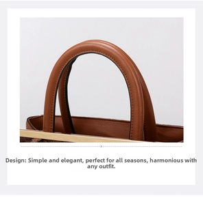 Close-up of brown crocodile texture leather handbag with gold metal trim and stitching