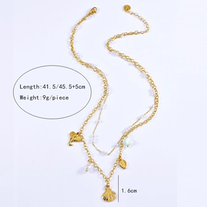 Detail of layered gold titanium necklace with starfish shell elephant and pearl charms