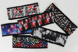 Detail view of colorful running waist packs with elastic mesh and graffiti patterns