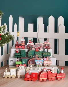 Detail of wooden Christmas train set with Santa, snowman and tree figurines on carriages