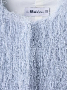Close-up of light blue jacket featuring long fringe texture and soft faux fur detail