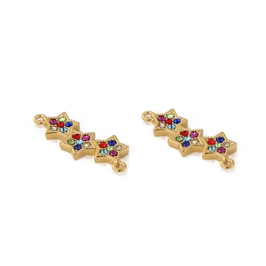 Detailed macro view of triple star gold jewelry pendant with colorful inlaid rhinestones