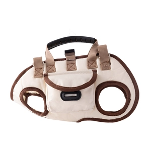 Portable beige dog carrier vest with brown trim, featuring a top handle and storage pocket