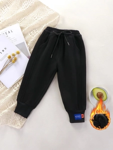 Thick black kids fleece joggers with drawstring waist and difference label on ankle