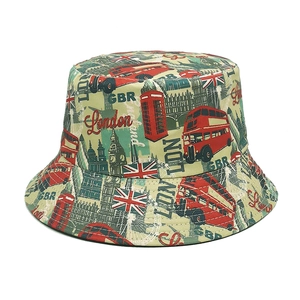Detailed view of London elements print on cotton bucket hat with iconic red bus and Big Ben