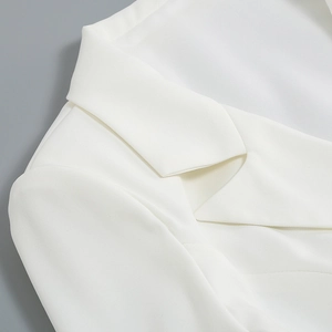 Detail shot of the professional white blazer lapel and high-quality woven fabric texture