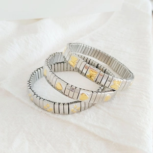 Three-piece stretch stainless steel bracelet set with gold heart, butterfly and flower charms