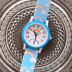 Blue quartz kids watch with rainbow patterns on silicone strap and round dial
