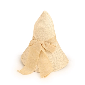 Close-up of wide bow decoration and detailed straw weave on a beige summer sun hat