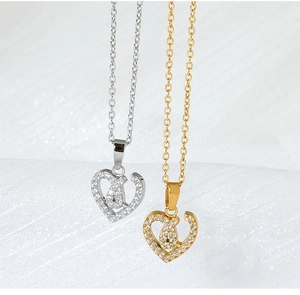 Detailed macro shot of gold and silver heart-shaped necklaces with inlaid zircon stones