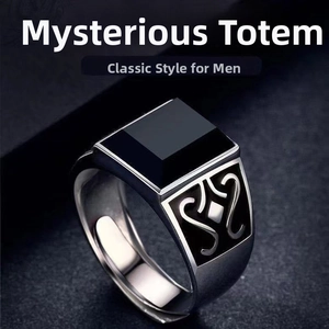 Macro shot of men's vintage silver ring featuring a square black gem and totem engraving