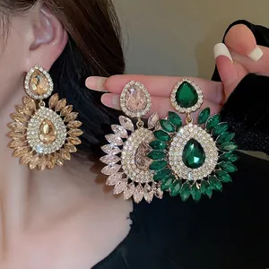 Dramatic floral teardrop earrings with sparkling crystals in gold and pink finish