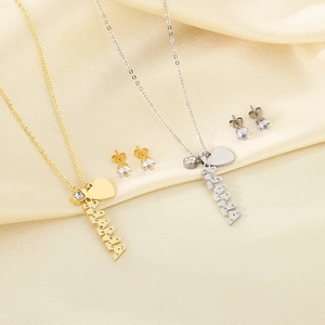 Gold and silver MAMA necklace sets with heart pendants and crystal earrings on silk