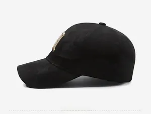 Detail view of black camouflage baseball cap with gold embroidery on the side