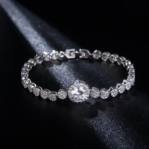 Close-up of heart-shaped silver bracelet with halo-set zircon and sparkling accents