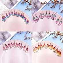 Macro detail of gradient butterfly wing earrings in blue and purple hues