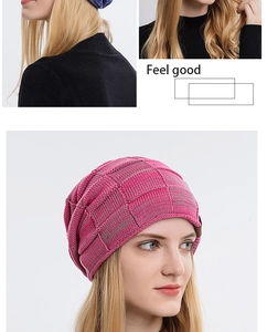 Close-up of mixed rose red and grey knit beanie with leather patch detail