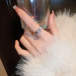 Detail of silver double-layer ring featuring a white pearl and a rectangular zircon stone