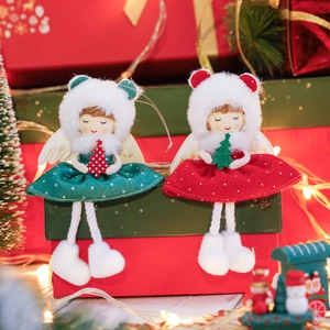 Red and green Christmas plush angel girl hanging ornaments on red gift boxes