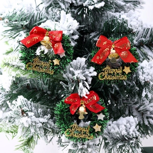 Mini Christmas star wreaths with red bows and gold bells for festive decoration