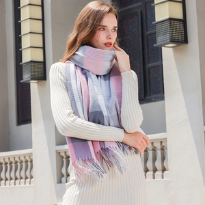 Chic rainbow plaid tassel scarf with pink and grey blocks worn by model in natural light