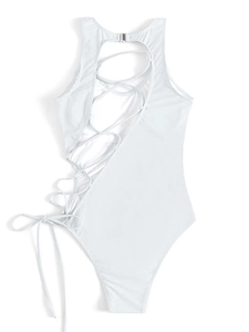 Detail of white one-piece swimsuit with silver metal buckle and crisscross back straps