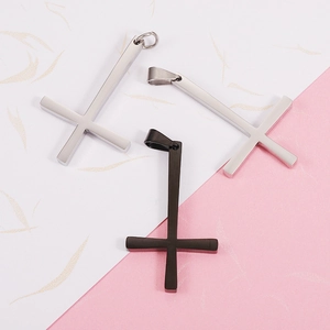 Set of three polished stainless steel cross pendants in silver and black metal finishes