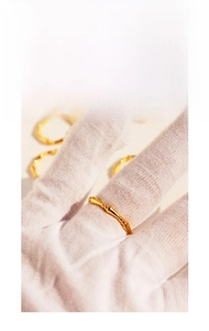 Macro view of gold plated bamboo style ring featuring minimalist texture and sleek design