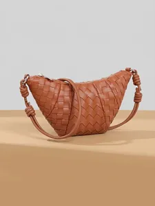 Brown hand-woven leather crescent bag with a knotted strap in a minimalist style