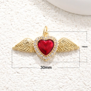 Detail view of a 30mm x 14mm heart pendant with gold wings and red center stone