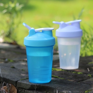 Detail of portable shaker bottles with handle and non-slip texture on stone stairs