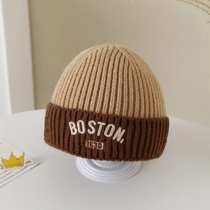 Detailed close-up of the BOSTON embroidery on this two-tone knit winter hat