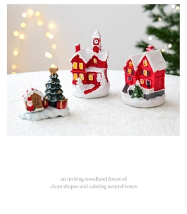 Charming red miniature resin Christmas house figurines with snow details on white ground