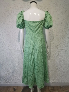 Detail view of floral green dress back with puff sleeves and invisible zipper closure