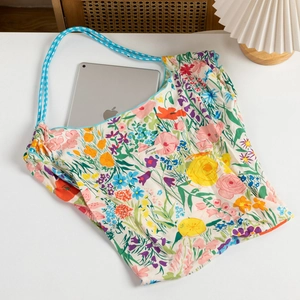 Floral tote bag showing capacity with a tablet inside and blue checkered strap